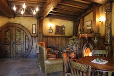 a living room filled with furniture and a fire place next to a table in front of a fireplace