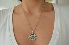 It's an amazing short antique silver coin necklace with an engraved Evil Eye protection pendant. If you're looking for a delicate feminine necklace - yet supernatural, easy to wear that's the perfect jewelry for you. The Evil Eye is a popular symbol, found in many cultures and it is extremely prominent in Greece and many more Eastern countries. The Evil Eye is a curse cast by a malevolent stare. In Greek culture though the evil eye can be cast from the stares of admiration too. The victims suffe Silver Delicate Chain Bohemian Jewelry, Bohemian Silver Jewelry With Delicate Chain, Silver Bohemian Jewelry With Delicate Chain, Bohemian Style Silver Stainless Steel Jewelry, Bohemian Silver Stainless Steel Jewelry, Bohemian Silver Charm Necklace With Delicate Chain, Vintage Silver Charm Necklace With Delicate Chain, Silver Coin Necklace With Delicate Chain For Gift, Silver Metal Evil Eye Jewelry