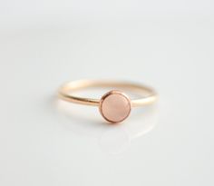 14k Yellow Gold Filled Ring with 5mm genuine rose quartz. Stackable ring. Also available in sterling silver and rose gold filled. This ring is made to order in your size. If you don't see your size available please feel free to message me. All orders ship in a gift box. If you are ordering multiple items and want them boxed separately, please let me know in the notes at checkout. I ship via USPS. Please review the estimated delivery date and processing times. Processing times vary based on how b Rose Gold Jewelry With Round Band, Tiny Rose Gold Stackable Rings, Delicate Rose Gold Stackable Rings With Round Band, Minimalist 14k Rose Gold Round Jewelry, Minimalist Rose Gold Round Band Jewelry, Simple Rose Gold Round Band Jewelry, Simple 14k Rose Gold Ring, Simple Rose Gold 14k Ring, Minimalist Rose Jewelry For Anniversary