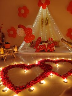 valentine's day decorations with candles and lights in the shape of heart shaped hearts