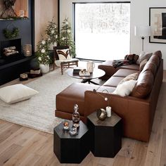 a living room filled with lots of furniture and a fire place in front of a window