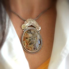 "Crazy lace agate necklace sterling silver large oval lace agate pendant orange brown beige antique bohemian style, artisan boho jewelry A beautiful large oval crazy lace agate stone with hues of brown, beige and orange in sterling silver statement pendant. Lovely autumn colors and winter colors too. The stone is set inside a bezel and framed with braided wire . On top of it there is an engraved antique floral pattern. I have oxidized it to bring out the details and achieved this bohemian look T Bohemian Jewelry With Oval Pendant Natural Stones, Bohemian Sterling Silver Oval Pendant Necklace, Silver Oval Bohemian Necklaces, Bohemian Agate Round Pendant Necklace, Bohemian Agate Round Pendant Jewelry, Bohemian Medallion Gemstone Necklace, Bohemian Agate Necklace With Large Pendant, Bohemian Silver Necklace With Large Stone, Bohemian Oval Agate Necklace