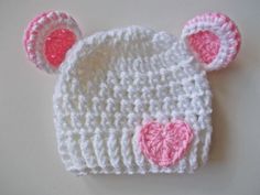 Welcome to our adorable collection of handmade baby accessories! Our crochet baby bear hat in pure white, adorned with a sweet pink heart accent, is designed to keep your little one both cozy and charming.     Exceptional Softness: Crafted from the finest yarn, this hat ensures your baby's comfort with its soft and gentle touch.   The hand-crocheted pink heart adds a touch of love and cuteness to this classic white hat.     Perfect Fit: Available in various sizes, this hat guarantees a snug and Cute White Crochet Hat For Gift, Cute White Crochet Hat For Gifts, Cute White Crochet Hat As Gift, Cute Cream Hat For Gift, White Adjustable Beanie For Babies, Whimsical White Mini Hat For Gifts, Whimsical White Mini Hat As Gift, Playful White Crochet Beanie Hat, Cute White Hat For Birthday