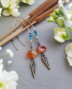 "These simple, long earrings are a perfect pop of color for your summer style! They feature genuine Carnelian/Red Agate beads with textured, triangle charms and blue-green crystal accents. The earrings are approximately 3.25\" long but lightweight. The earwires are antique brass-plated and are 100% nickel-free. (Please Note: These earrings are made-to-order and there may be slight variations from pair to pair.) Thanks for checking out the shop and feel free to drop me a line if you have any ques Bohemian Nickel-free Linear Earrings As Gift, Bohemian Style Nickel Free Linear Earrings As Gift, Bohemian Dangle Linear Earrings, Bohemian Linear Earrings, Bohemian Dangle Linear Earrings Nickel Free, Bohemian Dangle Nickel-free Earrings, Bohemian Dangle Nickel-free Linear Earrings, Bohemian Nickel-free Dangle Earrings, Bohemian Dangle Linear Earrings For Gift