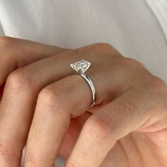 a woman's hand with a diamond ring on it