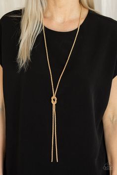 A glistening strand of lengthened gold popcorn chain delicately knots at the chest, creating an edgy tasseled pendant. Features an adjustable clasp closure. Featured inside The Preview at ONE Life! Sold as one individual necklace. Includes one pair of matching earrings. P2ED-GDXX-119XX Chic Gold Lariat Long Necklace, Chic Gold Long Lariat Necklace, Chic Long Gold Lariat Necklace, Adjustable Lariat Chain Necklace For Parties, Chic Gold Lariat Jewelry, Party Lariat Gold Chain Jewelry, Chic Gold Metal Lariat Necklace, Chic Gold-tone Lariat Necklace, Gold Lariat Clavicle Chain Necklace