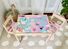 a child's table and chair with cupcakes on it