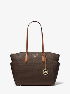 Our Marilyn carryall is the ultimate tote bag for everyday wear. The brand’s iconic “MK” initials leave a memorable mark, while the structured silhouette unzips to reveal a spacious interior with dedicated pockets for your daily essentials. We love how the slender leather straps easily slip over your shoulder to ensure on-the-go ease. Tote Bag Michael Kors, Affliction Clothing, Logo Tote Bag, Bag Michael Kors, Media Logo, Bags Logo, Wedge Pumps, Medium Tote, Designer Gifts