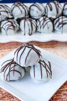 chocolate covered truffles on a white plate