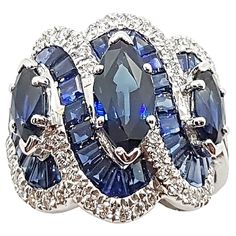 Blue Sapphire 1.93 carats (Center Marquise) with Blue Sapphire 1.55 cts (Total Side Marquises) with Sapphire 7.92 carats (Total Baguette) and Diamond 0.57 carat Ring set in 18 Karat White Gold Settings Width: 2.0 cm Length: 2.0 cm Ring Size: 52 Total Weight: 11.33 grams "We first opened doors in 1980 when it was then situated in the vicinity of the Victory Monument; a small and modest storefront with a couple of counters. From its humble beginnings to where it stands today, our company has prove