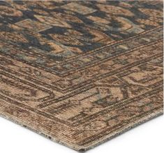 a brown and black rug with an intricate design