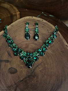 "Emerald necklace set with drop cluster crystal rhinestone necklace and earrings set are a great statement piece!  Size of earrings: 1.75\" Long.  Style: pierced and clip on available! Necklace 17\"long with 2.5\" chain extender Decor Dangle Size: 1.5\" drop width  Color: emerald green Base metal color: silver More colors available upon request, just message us! Need a matching bracelet to complete your look?  https://www.etsy.com/listing/1642297157/emerald-rhinestone-bridal-bracelet?click_key=6d0bb6f568dbf21a2dc7d909e9f1a2facb8c8779%3A1642297157&click_sum=431a0c11&ga_search_query=emerald&ref=shop_items_search_5&frs=1&sts=1 https://www.etsy.com/listing/621708283/emerald-bracelet-emerald-rhinestone?ref=shop_home_active_29&frs=1 https://www.etsy.com/listing/562630232/emerald-rhinestone-brace Emerald Jewelry Necklaces, Green Sparkling Stones Jewelry Sets For Party, Green Crystal Jewelry With Rhinestones, Green Crystal Jewelry Sets With Sparkling Stones, Green Crystal Rhinestone Necklace For Wedding, Green Jeweled Rhinestone Crystal Necklace, Green Jeweled Crystal Rhinestone Necklace, Green Crystal Rhinestone Necklace, Green Crystal Jewelry Sets With Jewels