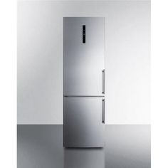 a silver refrigerator freezer sitting on top of a counter next to a white wall