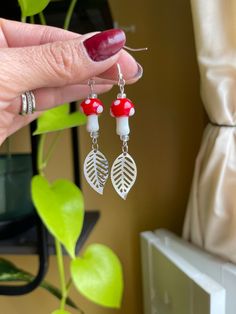 Nature Inspired Mushroom Earrings! Great gift Idea for nature lovers! -Cottagecore, mushroom and plant themed dangle earrings. -ALL HOOKS OF EARRINGS ARE NEW! -All my jewelry (except the earring hooks & wires) are created by me with recycled & up-cycled materials. -Mushroom is made out of glass. -Hooks are sterling silver, hypoallergenic. -All earrings are UNIQUE you get EXACTLY the one you see in the pictures! -I package the earrings in a box and then inside a bubble mailer for extra protection Mushroom Design Dangle Earrings For Gift, Mushroom Design Dangle Earrings As Gift, White Mushroom Design Earrings For Gift, White Mushroom Design Earrings As Gift, White Earrings With Mushroom Design As Gift, White Mushroom Design Drop Earrings, Red Mushroom Design Earrings Gift, White Dangle Earrings With Mushroom Design, Nature-inspired Nickel Free White Earrings