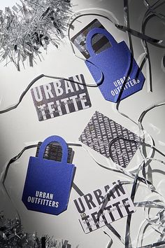 an assortment of blue and silver tags on a piece of paper that says urban outfitters