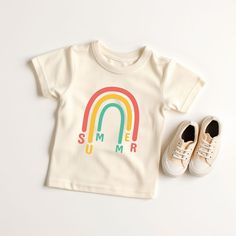 Looking for a cute tee for your kids? We have the perfect Rainbow Summer graphic tee addition to their closet! Also available in toddler tees. Family Matching Summer T-shirt With Screen Print, Screen Print Short Sleeve T-shirt For Playtime, Cute Letter Print T-shirt For Playtime, Unisex Short Sleeve T-shirt For Playtime, Rainbow Print Cotton T-shirt With Short Sleeves, White Cotton T-shirt With Rainbow Print, Summer Playtime Tops With Letter Print, Rainbow Graphic Print Top For Summer, Rainbow Graphic Print Tops For Summer