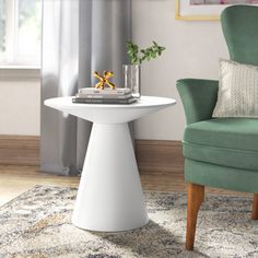 a green chair sitting next to a white table on top of a carpeted floor