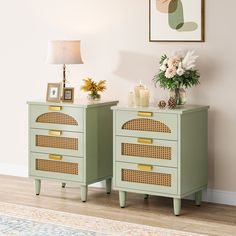 two green chests with wicker drawers in front of a pink wall and white flowers