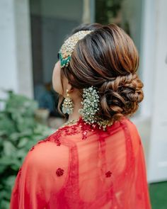 a woman in an orange dress with some jewelry on her head