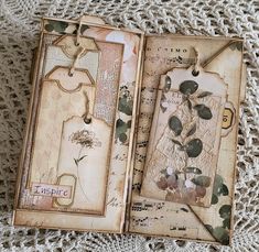 an open book sitting on top of a doily covered table next to a crocheted cloth