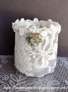 a close up of a lace cup on a doily with an ornate design in the middle