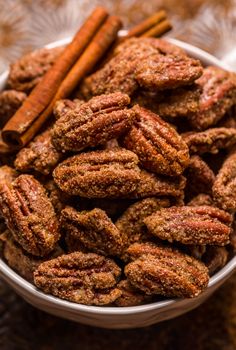 a bowl filled with nuts and cinnamon sticks