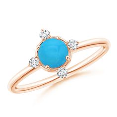 a yellow gold ring with an oval turquoise stone and three small white diamonds on the side