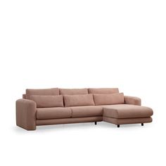 a beige sectional sofa with pillows on the back and footrests, in front of a white background