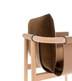 the back of a chair with a cushion on it's seat and armrests