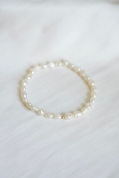 The Charlotte Bracelet features 4-5mm freshwater pearls with a 3mm 14k gold filled bead hand strung on a durable stretchy string. 14k gold-filled jewelry features a thick layer of 14-karat gold bonded to a base metal, typically brass. Unlike gold plating, this process uses pressure and heat to create a durable, high-quality finish that doesn't easily wear off. The gold layer in gold-filled jewelry constitutes at least 5% of the item's total weight, providing a luxurious appearance and long-lasting durability at a more affordable price than solid gold. Our 14k gold-filled pieces offer the beauty and elegance of gold while being resistant to tarnish, making them perfect for everyday wear. Bracelet Stacking, Gold Bond, String Bracelet, Handmade Bracelet, Bracelet Handmade, Gold Filled Jewelry, Bracelet Stack, Base Metal, Gold Plating