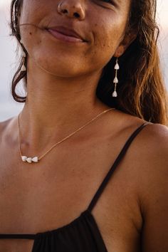 An ode to Hawaii, this necklace features three mother of pearl Pikake beads, wire wrapped onto an 18" gold filled chain. Pikake is the Hawaiian name for Jasmine, a popular lei flower in Hawaii. The Pikake flower was brought to the Hawaiian islands in the 1800’s and is a symbol of romance and love. Hawaii’s Princess Kaiulani loved the jasmine flower as well as peacocks, and named this flower after the Hawaiian word for peacock- pikake. Gold Pearl Beaded Bracelets, Pikake Lei, Pikake Flower, Princess Kaiulani, Lei Flower, Hawaiian Names, Flower Lei, Hawaii Jewelry, Island Jewelry