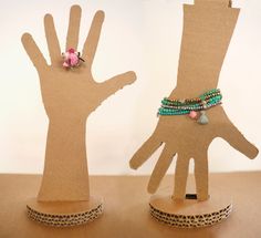 two hand puppets made out of cardboard with beaded bracelets and beads on them