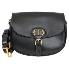 Expertly crafted with sleek black leather, the Dior Bobby medium bag exudes sophisticated elegance. This bag is perfect for any occasion and has a chic and minimalistic design. Despite small scratches on the front, it remains a timeless luxury. See pictures for reference. It comes with a leather strap. Black, 100% leather with golden hardware. Detachable strap. Includes original dust bag Cartier Panthere, Medium Bag, Timeless Luxury, Minimalistic Design, Black Bag, Medium Bags, Fashion Handbags, Purses Crossbody, Minimalist Design