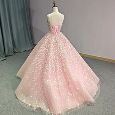 a pink ball gown with white flowers on it