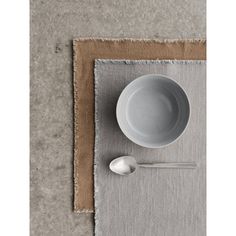 a bowl and spoon on a place mat