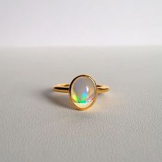 Natural Opal Ring-Fire Opal Ring-Oval Opal Ring-Dainty Opal Ring-Stackable Ring-Sterling Silver Ring-14k Solid Gold Ring-October birthstone ABOUT RING Gemstone - Natural Ethiopian Opal Gemstone shape - Oval (Cabochon) Gemstone Size - 6x8mm   ------------------------------------------------------------------------------------------------------------------------------------------------- Fast Shipping: It will take 1-8 business days to send out your item Material: 22k/20k/18k/14k/10k/9k Yellow Gold Minimalist Oval Cabochon Opal Ring For Anniversary, Oval Moonstone Ring In Yellow Gold Sterling Silver, Gold Oval Opal Birthstone Ring, Gold Oval Birthstone Ring With Polished Finish, Oval Yellow Gold Opal Ring In Sterling Silver, Yellow Gold Oval Opal Ring In Sterling Silver, Yellow Gold Oval Moonstone Ring In Sterling Silver, Gold Opal Ring With Oval Cabochon, Gold Oval Crystal Birthstone Ring