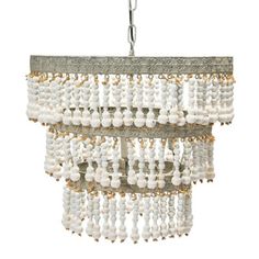 a chandelier hanging from the ceiling with white beads and gold trimmings