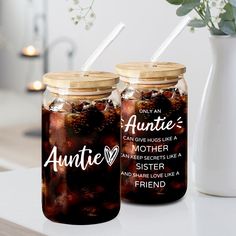 two jars filled with liquid sitting on top of a table