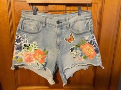 Upcycled cut off shorts with floral handmade patchwork. One of a kind pair! This design is available for made to order requests. We just ask that you send us your shorts or message us we might have your size in stock! Summer Denim Bottoms With Floral Patchwork, Summer Patchwork Cutoff Jean Shorts, Patchwork Cutoff Jean Shorts For Summer, Cotton Jean Shorts With Patches For Summer, Summer Cutoff Jean Shorts With Patches, Cutoff Denim Shorts With Patches, Summer Denim Jean Shorts With Patches, Summer Cutoff Shorts With Patches, Spring Cotton Jean Shorts With Patches