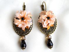 Elegant earrings made with polymer clay flower on brass. Unique and beutiful hand made in small fashion colection in Art Nouveau style. Dimensions of flower: 2,5 cm x2,5 cmor0.984 inch Dimensions of brass medallion : 3cm x 2.5 cm....or1.181inch x 0.984 inch Dimensions of whole earrings with glass beads: 6.5 cm....or 2.559 inch Weight:  13 g or....  0.0286 lb Handmade Brass Flower Earrings, Handmade Elegant Brass Flower Earrings, Elegant Handmade Brass Flower Earrings, Handmade Flower Polymer Clay Earrings, Hand Painted Flower Polymer Clay Earrings, Elegant Hand Painted Flower Earrings, Bohemian Polymer Clay Flower Drop Earrings, Handmade Polymer Clay Drop Earrings, Handmade Flower Earrings In Polymer Clay