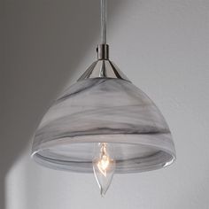 a light that is hanging from a ceiling in a room with a white wall behind it