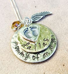 Memorial Necklace- Mommy Of An Angel * one inch hand stamped disc- hammered * 3/4 inch name date disc- hammered * sterling baby foot print charm * silver angel wing * sterling chain * birthstone * free gift wrap Just convo me to add a birthstone or initials to this design. Please visit more of my shop designs here http://www.etsy.com/shop/natashaaloha Personalized Stamped Round Disc Charm Necklaces, Personalized Stamped Round Disc Charm Necklace, Nickel-free Charm Necklaces For Keepsake, Memorial Hand Stamped Round Pendant Necklaces, Memorial Hand Stamped Round Pendant Necklace, Memorial Hand-stamped Round Pendant Necklaces, Hand Stamped Round Memorial Jewelry, Adjustable Hand Stamped Jewelry For Memorial, Hand Stamped Memorial Jewelry