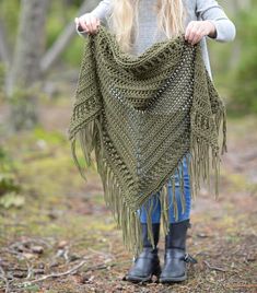 a woman is standing in the woods with her shawl draped over her head and she has long blonde hair