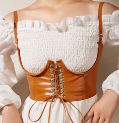 Elevate your style with this Palomino Brown Push-Up Bustier Gothic Harness Belt. Designed with a trendy faux leather corset aesthetic, this underbust suspender belt adds dimension and flair to any outfit. Key Features: Faux Leather Design: Crafted from high-quality PU leather for a sleek and durable finish. Adjustable Fit: Elastic band and adjustable shoulder straps ensure comfort and a customizable fit. Front Tie & Snap Closure: Easy to put on and take off, with a stylish tie-up front detail. T Waist Corset, Underbust Corset, Leather Corset, Waist Trainer, Punk Fashion, Brunei, Womens Tank, Tank Top Fashion, Belts