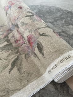 a close up of a table cloth with flowers on it and the words, flower guide written in black ink