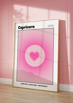 a pink poster with the word capricorn on it in front of a pink wall