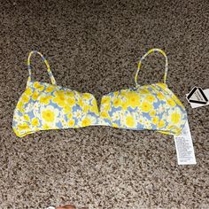 This Rvca Bikini Top In Size L Is Perfect For Any Beach Day. The Freya Shirred V-Wire Bralette Style Top Features Adjustable Spaghetti Straps, A Floral Pattern, And Is Made Of Polyester Material. The Multicolor Design And Beach Theme Make It A Great Addition To Any Summer Wardrobe. This Bikini Top Is Not Vintage And Is From The Rvca Brand. It Is A Regular Size And Type Of Bikini Top. Personalization Is Not Possible With This Item. Summer Vacation Swimwear With Padded Cups, Casual Underwire Swimwear For Vacation, Trendy Bra-friendly Swimwear For The Beach, Summer Bandeau Swimwear With Padded Cups, Trendy Padded Swimwear For Vacation, Trendy Padded Swimwear For Summer, Yellow Swimwear With Padded Cups For Vacation, Summer Swimwear With Padded Cups For Vacation, Yellow Padded Swimwear For Vacation