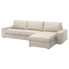 a white couch with a chaise lounge on it's left arm and footrests