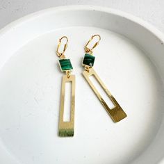 Rectangle Earrings | Green Stone Earrings | Brushed Gold | Dangle Drop Earrings | Geometric Earrings | Jewelry Gift These drop earrings feature chic rectangle pendants with luscious green stones. These earrings are perfect for adding a pop of color and sophistication to any outfit. * Synthetic * Signature brushed gold plating on brass * Leverback clasp * 2.75" drop . . . . . . . . . . . . . . . .   💎 MATERIALS We use high quality chains, stones and materials. If you have any questions about stone or component colors, please don't hesitate to contact us. . . . . . . . . . . . . . . . . . . . . . . . . . . . . . . . . .  📦 PRODUCTION & SHIPPING All pieces are made by Tracy in her studio in sunny Northern California, so please allow 2-3 days before your order is ready to be shipped. Keep in Green Stone Earrings, Long Statement Earrings, Rectangle Earrings, Green Stones, Earrings Geometric, Earrings Green, Gems Jewelry, Geometric Earrings, Jewelry Case