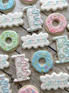 there are many decorated doughnuts on the table